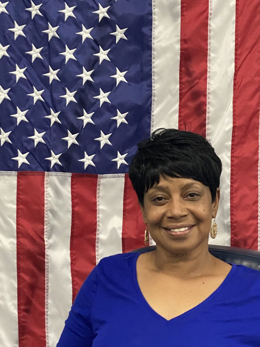 council member in front of American flag